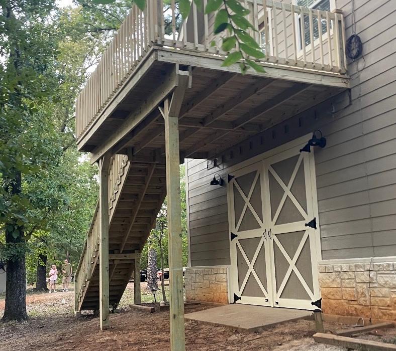 Second story deck with long stair run over a garage entry