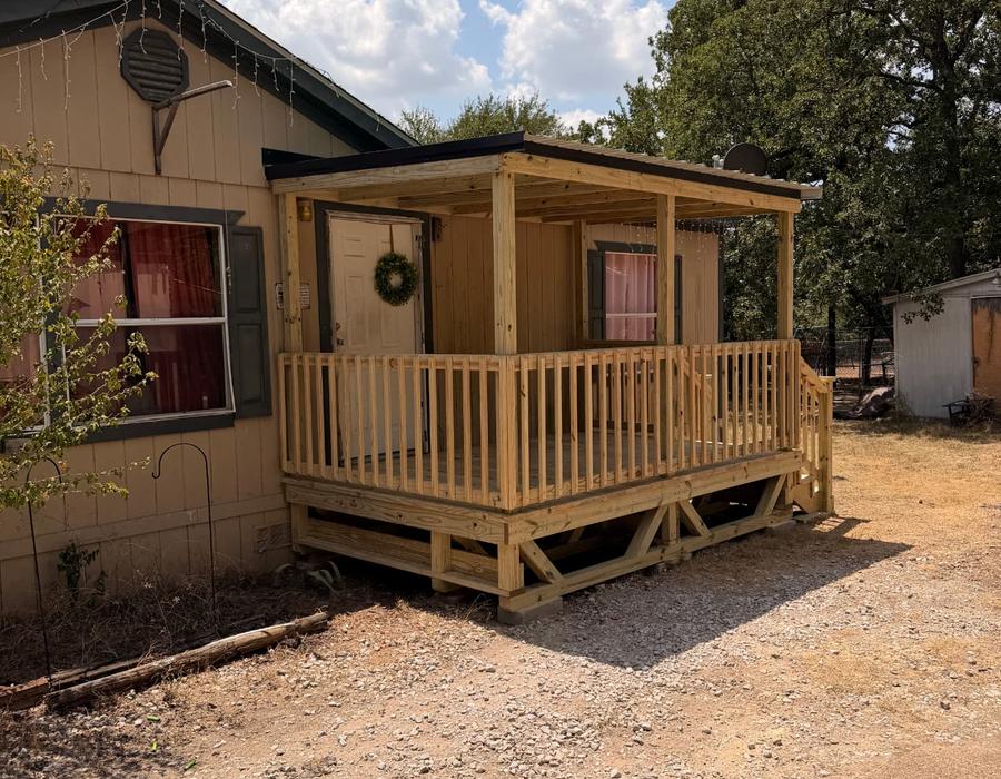Portable covered porch deck on blocks at a mobile home