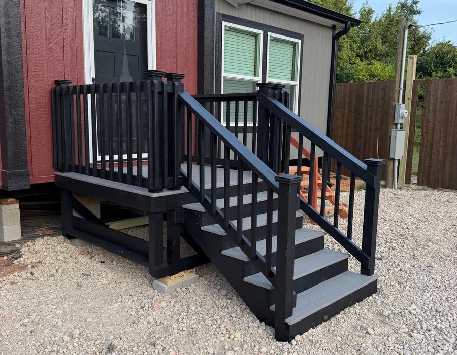 Portable black deck with gray stairs on blocks